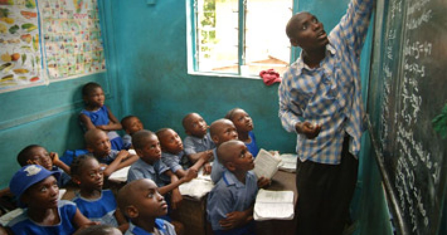 Pupils listen to their teacher at a school in Lagos, Nigeria