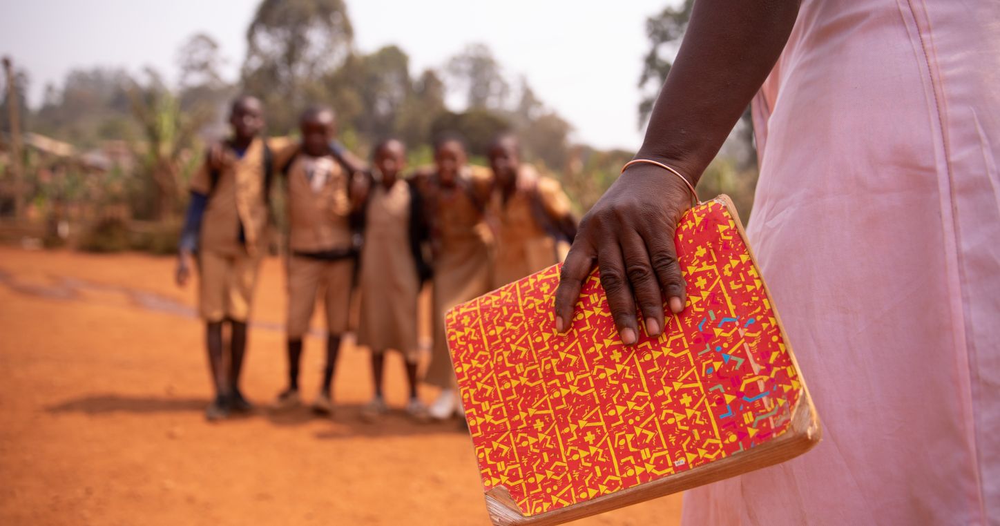 Teacher holding a book in Africa