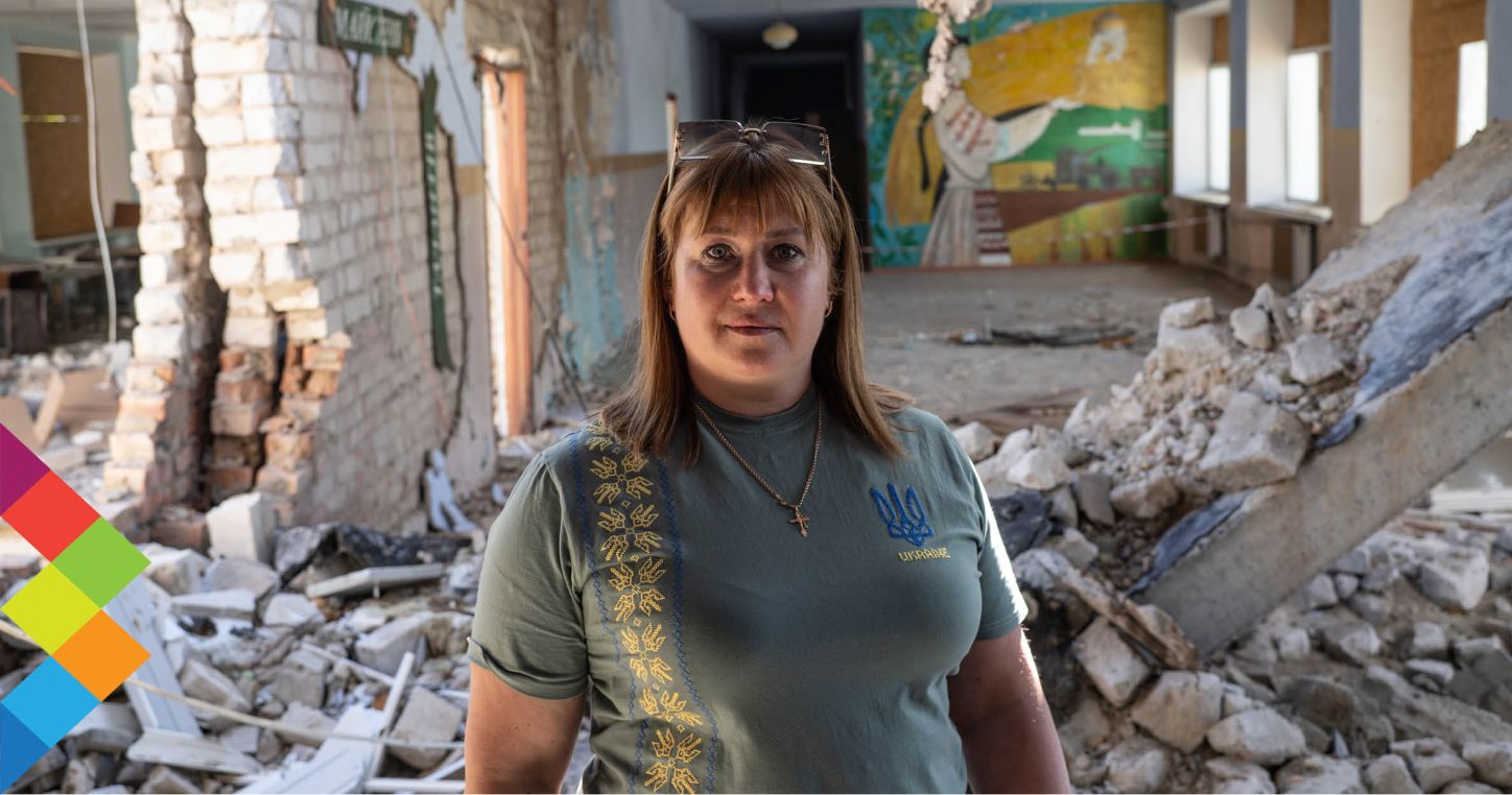 Director of the Snihurivka Lyceum, Victoria Chernysheva, in front of the damaged parts of the building in Snihurivka | Image credit: Oleksandr Techynskyi/AP Images for GPE